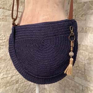 The Sak Ryder crochet crescent crossbody bag in navy blue with a tassel